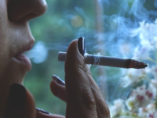 A person smoking a cigarette.