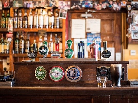 A bar with a focus on beer taps.