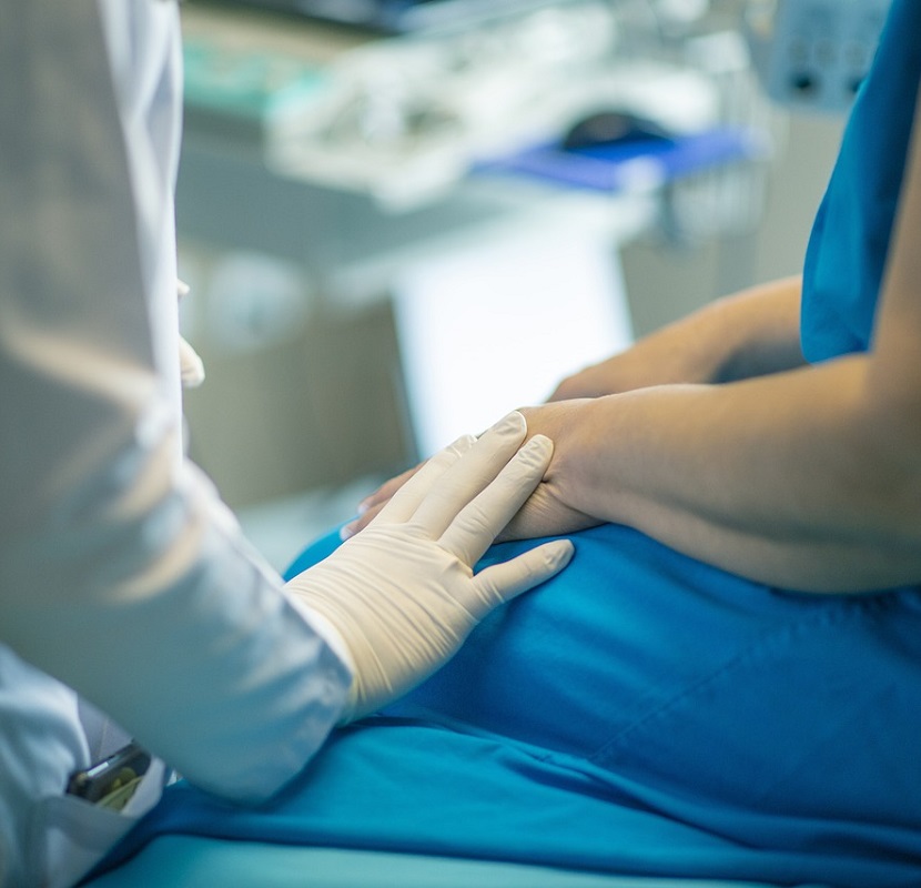 A healthcare provider and a patient in a medical facility.