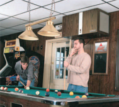 A commercial smoke eater installed in a room with a pool table to capture smoke, dust, and other air contaminants.